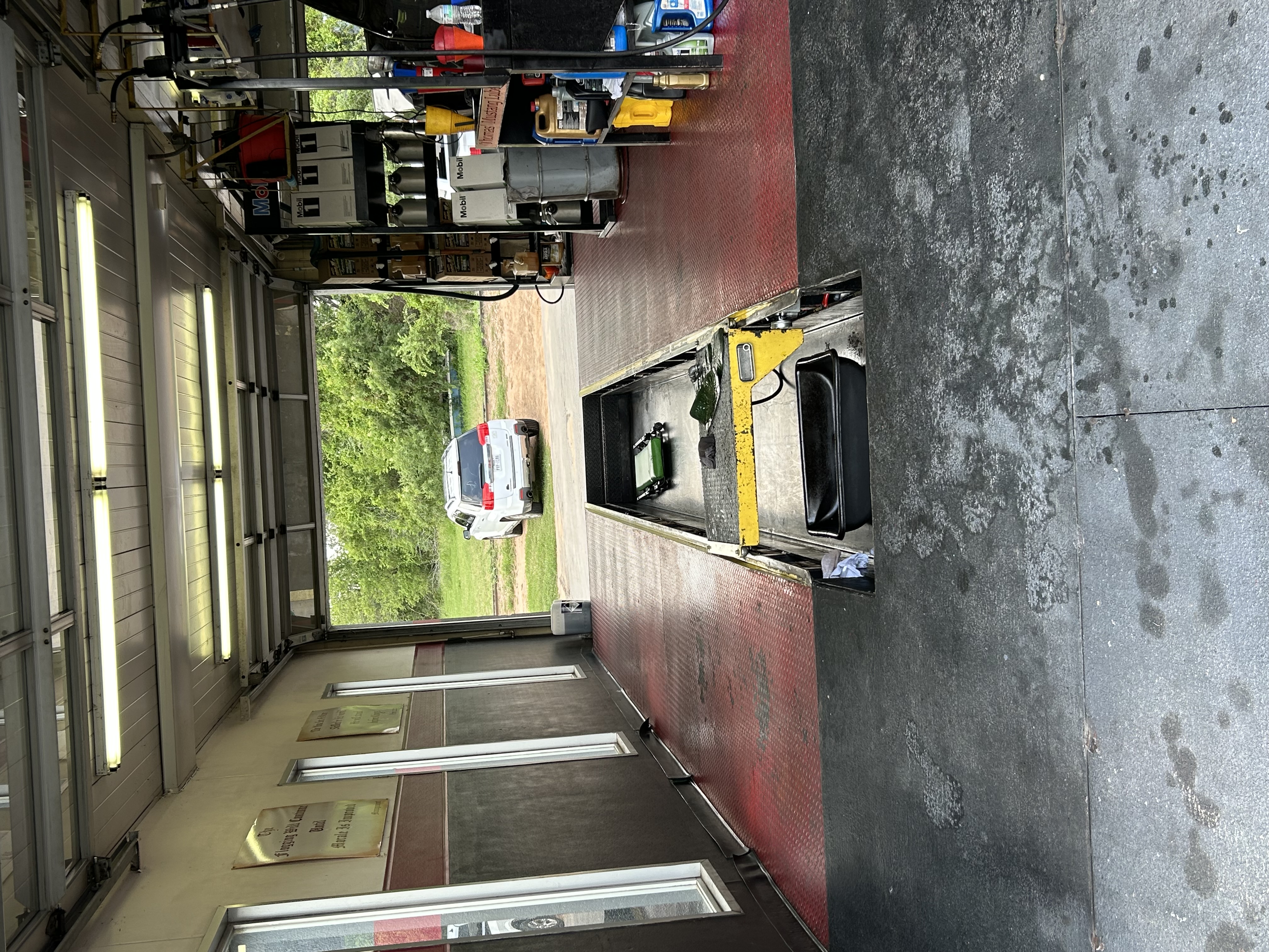 Technician working in the service bay at Thomas' Mustang Lube & Auto Repair in Kingsland, TX