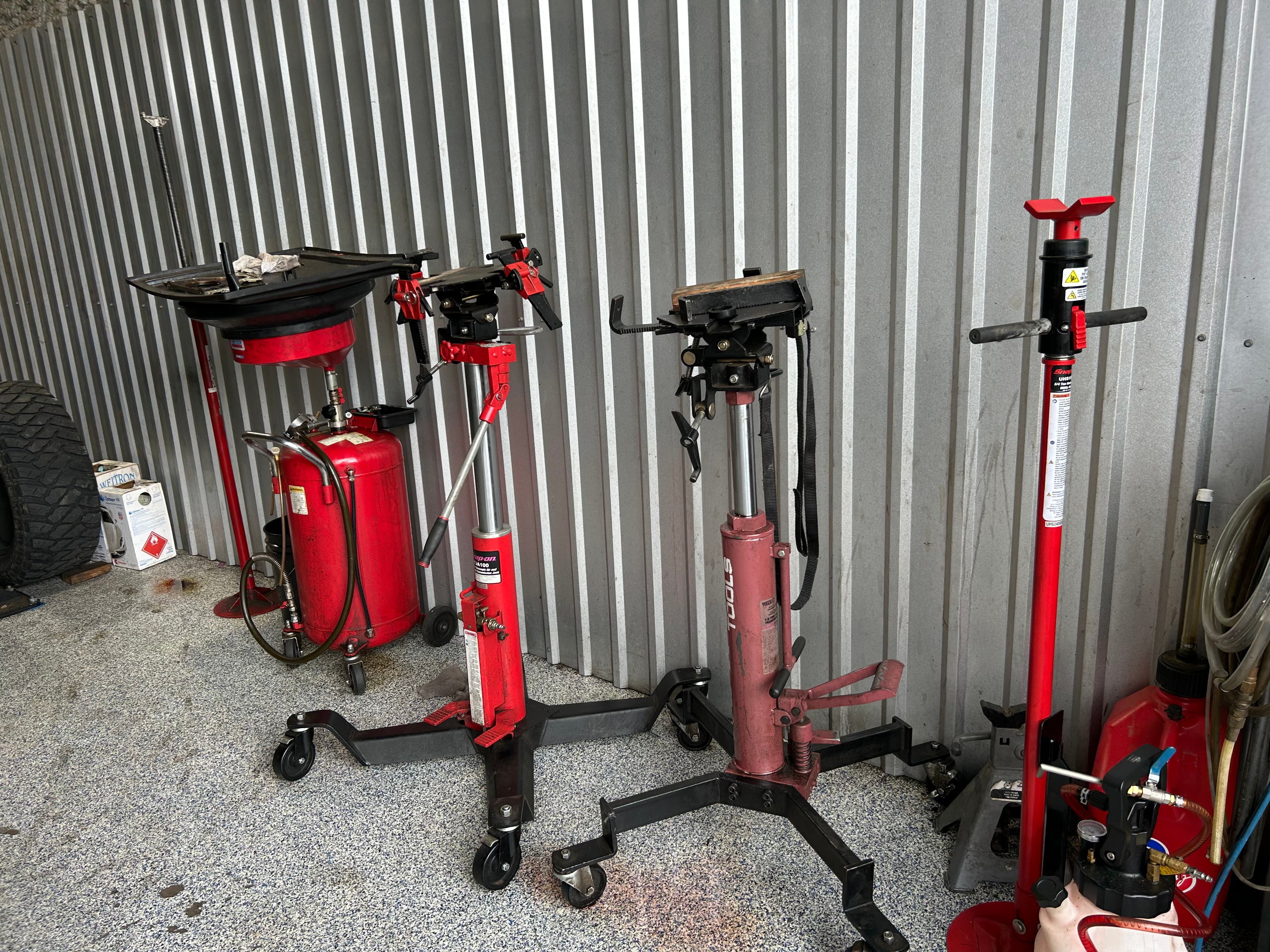Transmission jacks and fluid service equipment inside the Thomas' Mustang Lube & Auto Repair shop in Kingsland, TX
